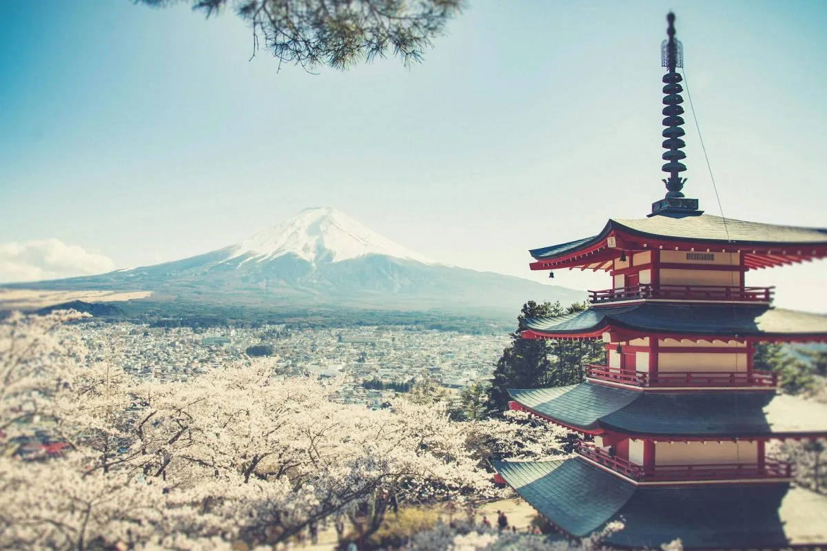 Chureito Pagoda with Mount Fuji in the background during cherry blossom season in Japan.