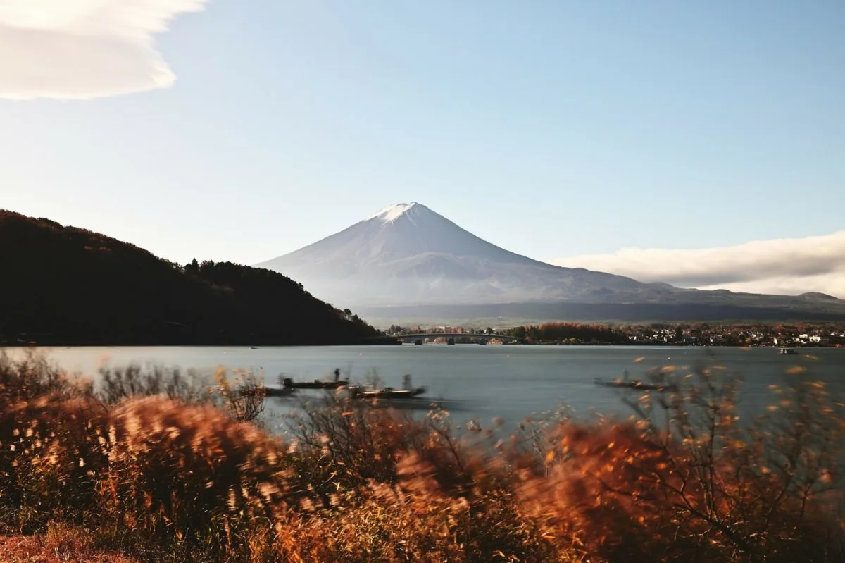 Mount Fuji viewed from Lake Kawaguchiko with autumn foliage in the foreground.